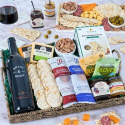 Artisan charcuterie tray with Cabernet wine, Belgian salami, and organic fig jam.