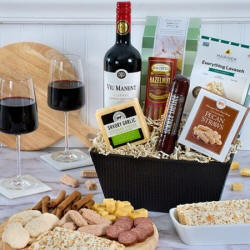 Classic red wine gift basket with Cabernet, cheese, sausage, and cookies.
