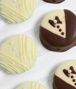 Dozen Oreo cookies decorated as bride and groom — white-chocolate gown and dark-chocolate tuxedo