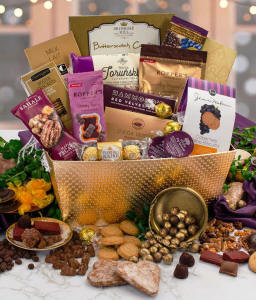 Gourmet chocolate and sweets gift basket with assorted truffles, cookies, chocolate-covered nuts, pecans, gummy bears, cocoa truffles, Ferrero Rocher, butterscotch candies, and wine biscuits displayed in a decorative gold container.