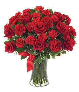 Bouquet of red roses and carnations in a glass vase, a love and romance gift