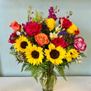 Sunflowers, roses, lilies in a vase