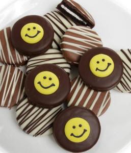 Dozen Oreo cookies dipped in milk, dark  white Belgian chocolate with smiley-face candies and chocolate drizzle