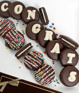 12 Belgian chocolate-covered Oreo cookies spelling 'Congrats' with rainbow sprinkles