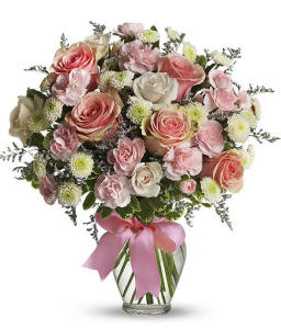 Cotton Candy bouquet with light pink and white roses, mini carnations, and green poms arranged in a glass vase with a pink bow. $44.99 Same day delivery available