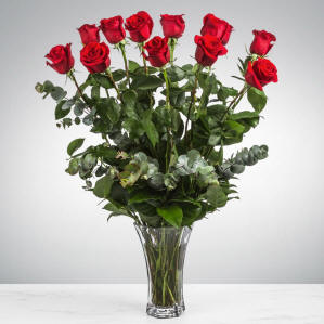A vase filled with long stemmed roses