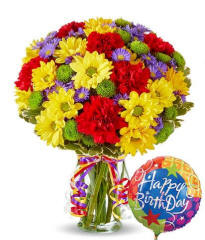 festive birthday flowers in a clear glass vase ready for same day delivery