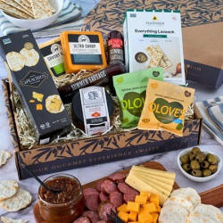 Deluxe gourmet meat and cheese sampler with savory meats, cheeses, crackers, and more.