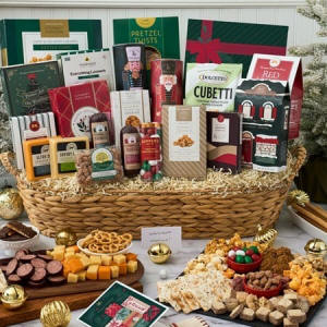 Huge Christmas gift basket overflowing with gourmet holiday snacks, chocolates and treats