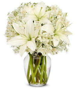 Ivory sympathy flower bouquet in a clear glass vase