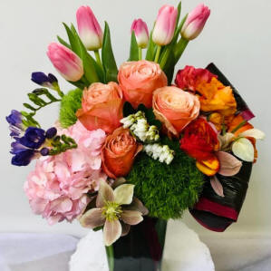 Roses, tulips and other mixed flowers in a vase