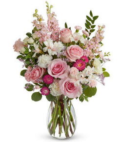 Mothers day flowers soft pearl colored flowers in a clear glass vase