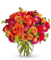 Sweet birthday flowers in a clear glass vase ready for delivery